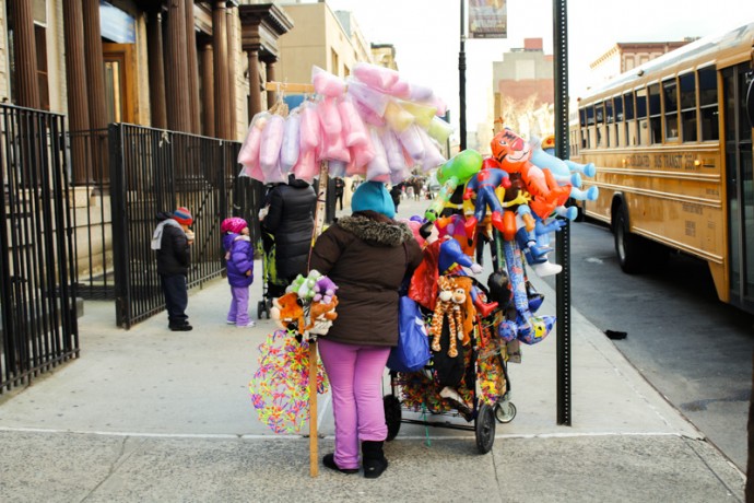 Women selling plastic inflated toy ballons on East 106th Street between Second and First Avenue in front of the Amber Charter School.