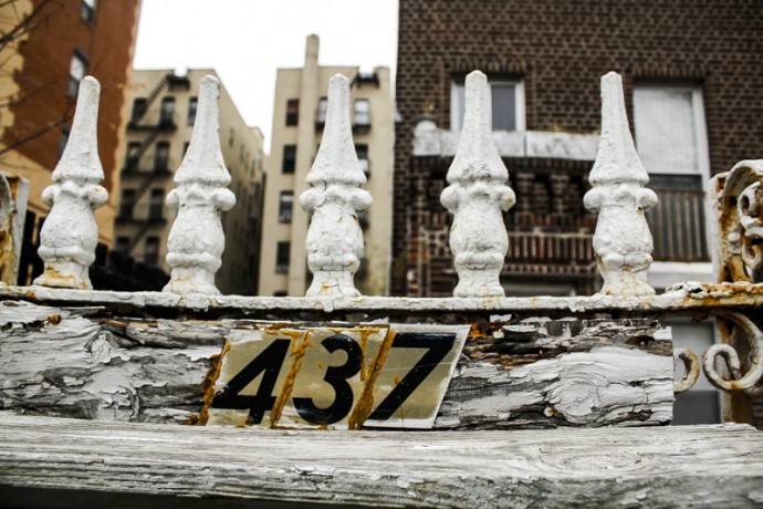 Top of the rusty white gate at 437 East 116th Street.