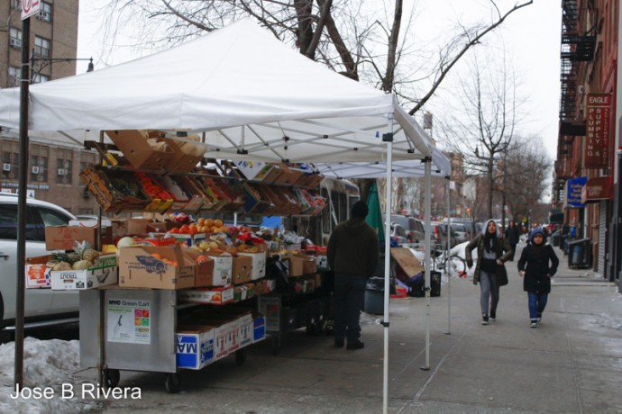 Daytime view of the vegetable stand on East 116th Street and near the corner of Second Avenue.