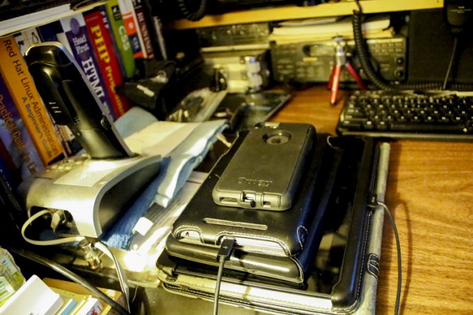 Three tablet and an iPhone still life. All were being charged.