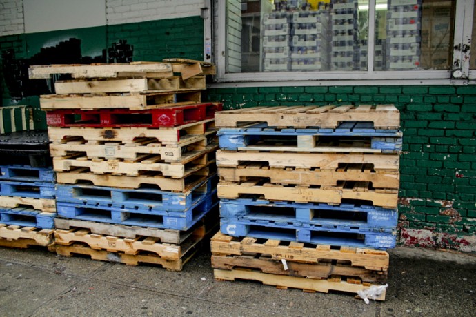 Colorful wooden palettes outside of supermarket at East 110th Street between Lexington and Third Avenues.