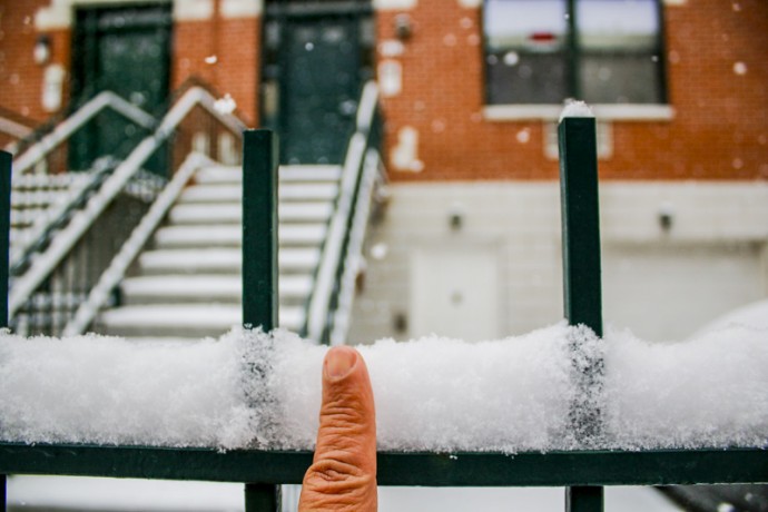 Measuring snow fall with one finger at East 110th Street between Second and First Avenues.