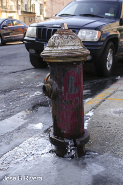 A red rusty water hydrant.