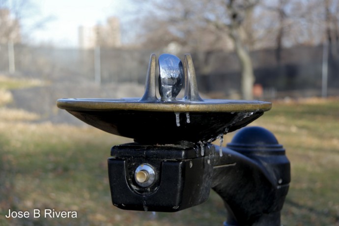 Metallic water fountain with frozen water droplets in Central Park