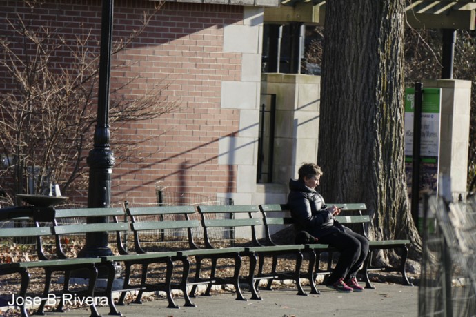 Lady sitting in Central Park bench.