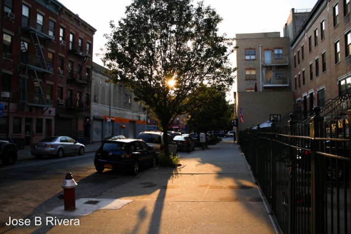 Sun beginning to set on July 28th. As seen from East 111th Street between Second and Third Avenues, looking West.