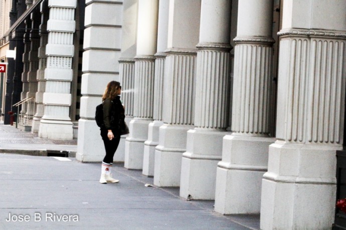 This lady was window shopping. You can't make out the store window in between these great columns. Taken near the Flat Iron Building downtown.