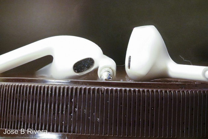 iPhone ear buds on a jar lid.