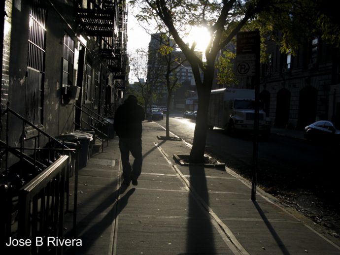 Man walking down East 111th Street between Third and Second Avenue. He was heading toward Second Avenue, this cool Friday morning.