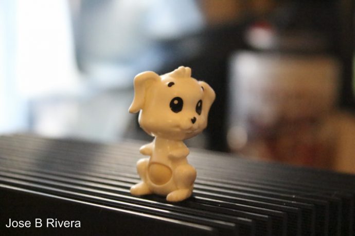 Macro close up photo of a Tiny Dog Toy, which swivels via its belly. This is a one inch tall figure.