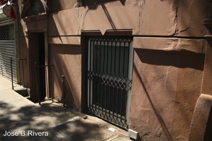 Foot level building window on East 116th Street.