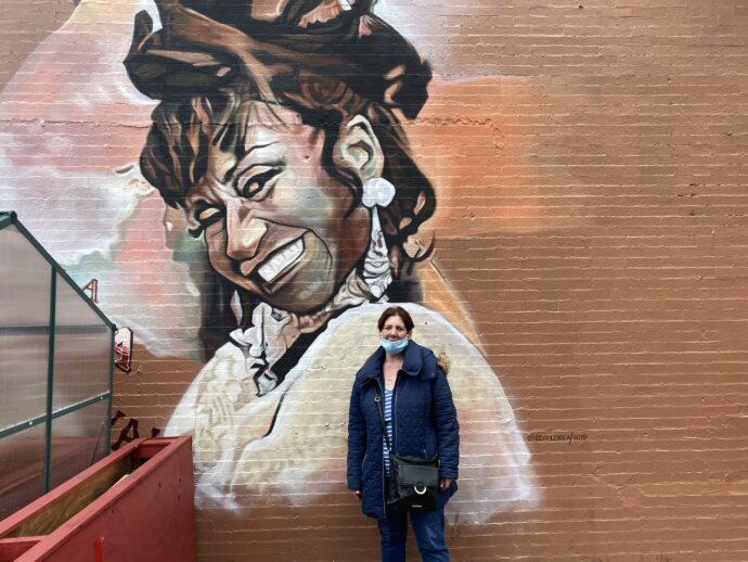 My wife stands in front Celia Cruz Mural.