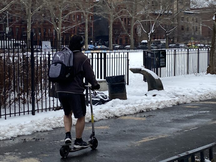 Hot or Cold? Man on Scooter dresses warmly on top but wears shorts. Surely it can't be hot and cold at the same time. I don't understand this look. It screams of stupidity of those wearing such clothing.