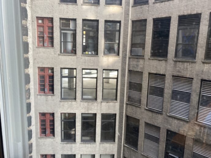 Window Reflections from inside a city block where all the back of the buildings face each other.