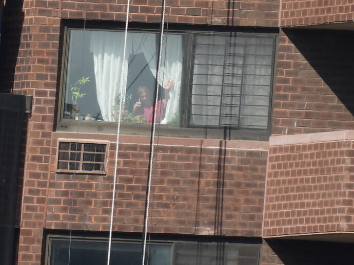 Waving Wife. I took this photo from Ward Island. I was across the East River. My wife is on the phone talking to me so that I could arrange this shot.