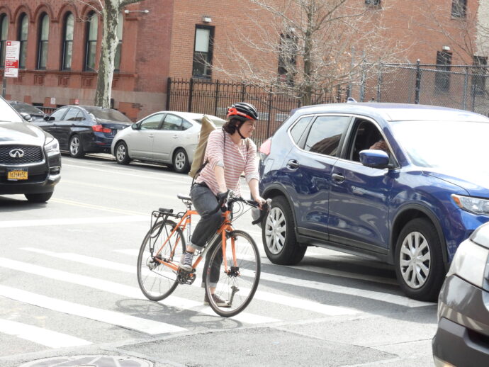 Lady Biker on Park Ave and East 106th Street waiting for the light to change.